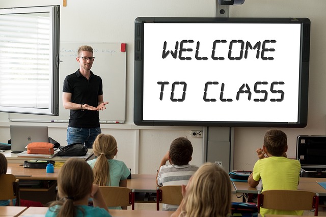 Teacher teaching a class of children